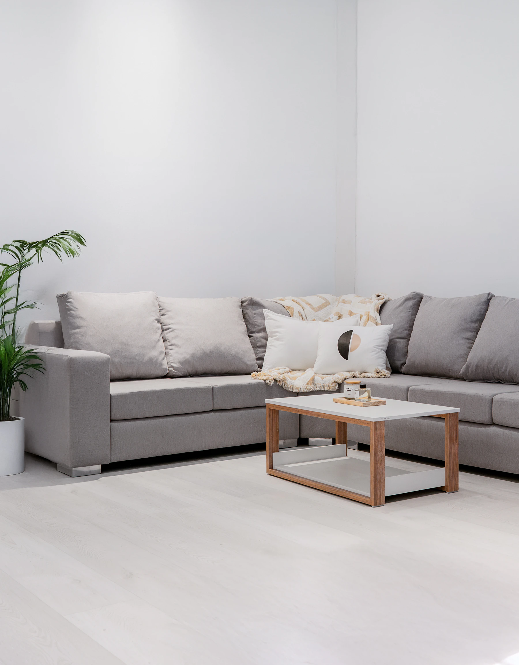 A modern living room with a gray sectional sofa