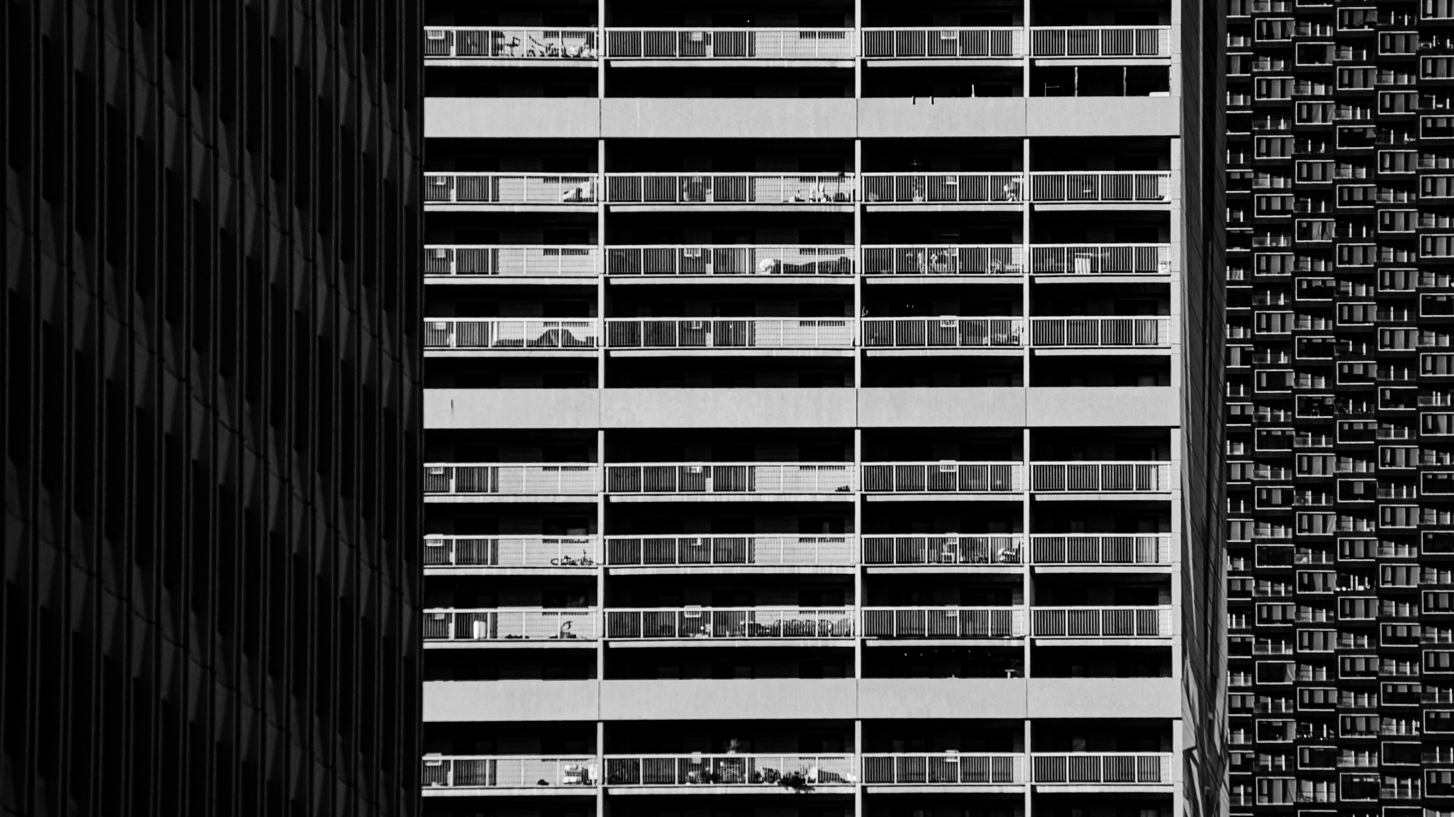 Modern building facade with repeating windows and textures.