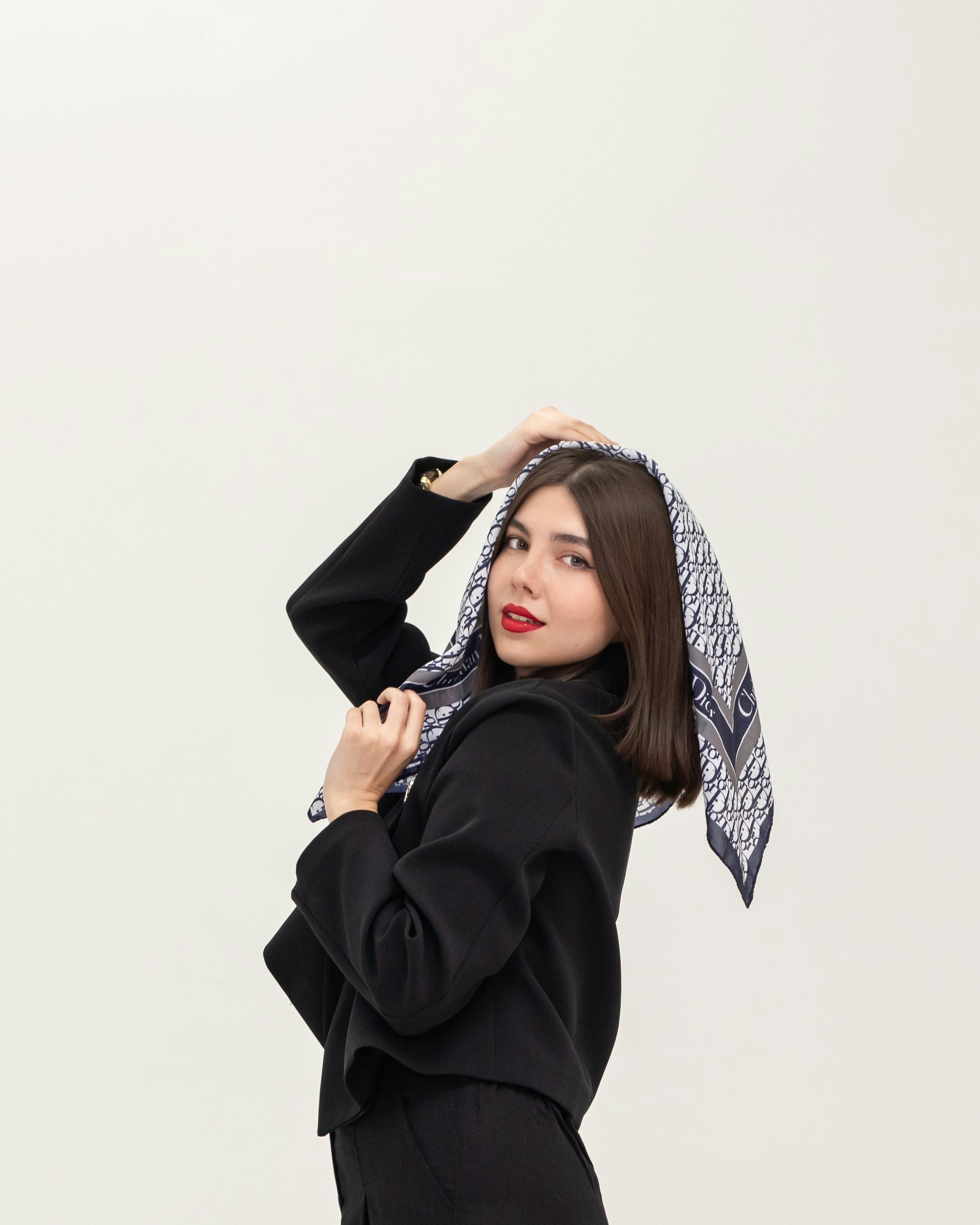 Woman in black jacket with patterned scarf