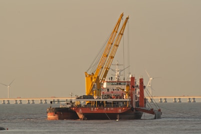 A large dredging vessel with cranes on the water.
