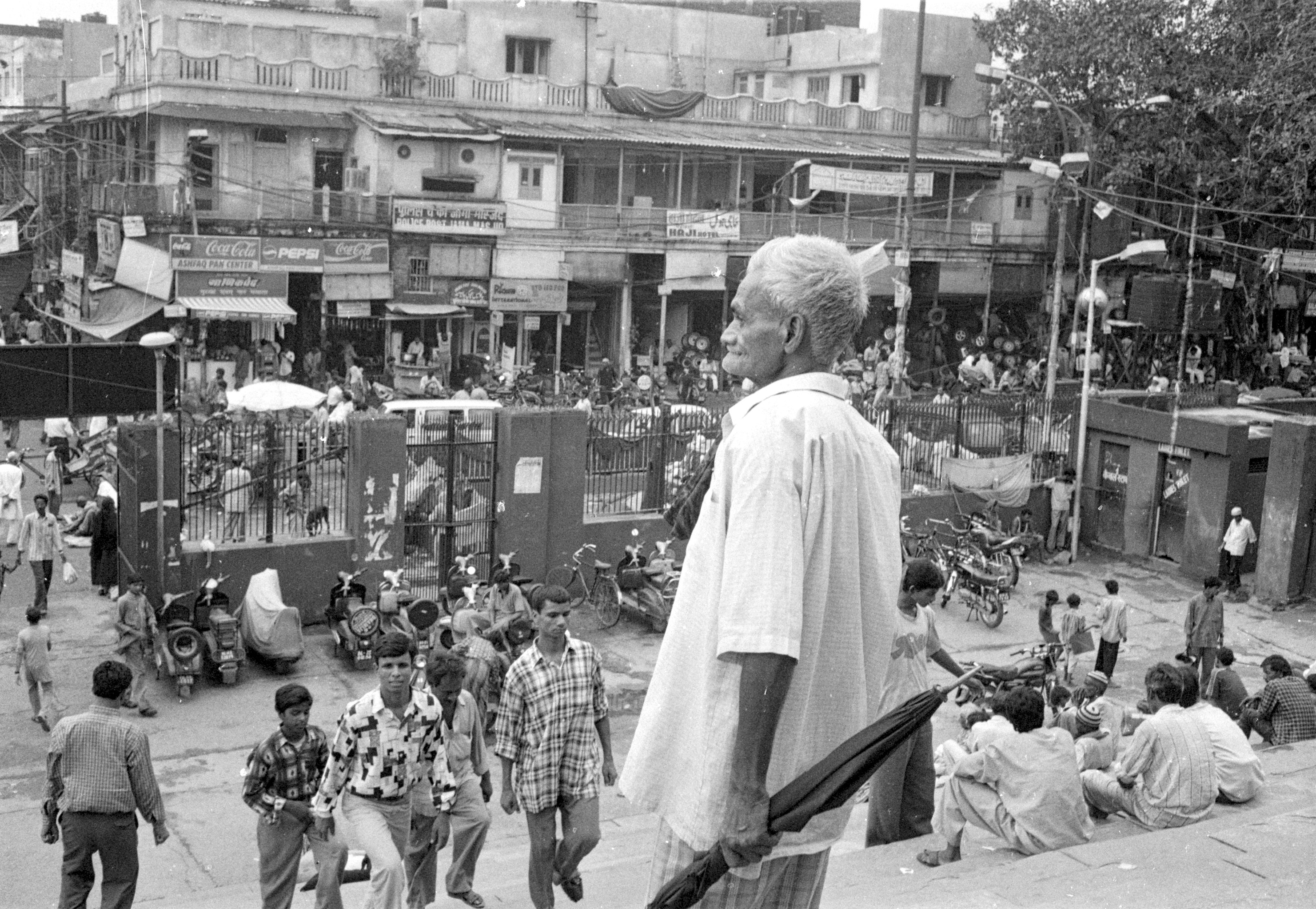 A split image showing India's map, with a demographic contrast between a densely populated northern state and a less populated southern state, symbolizing the delimitation debate.