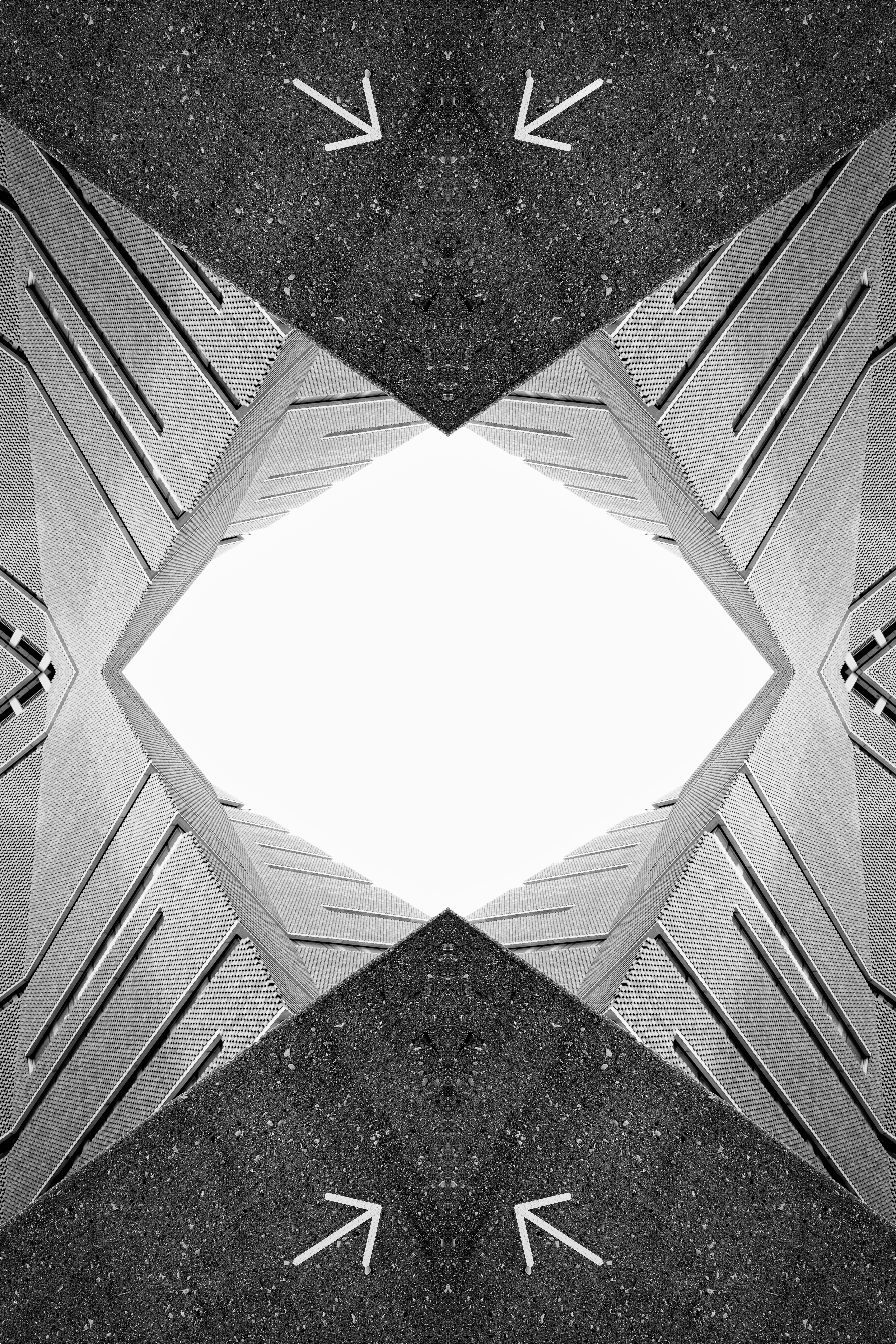 Abstract architectural shapes with white arrows pointing inward.