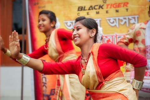 Two women in traditional attire performing a dance