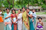 Group of women and children in a rural village setting
