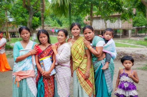 Group of women and children in a rural village setting