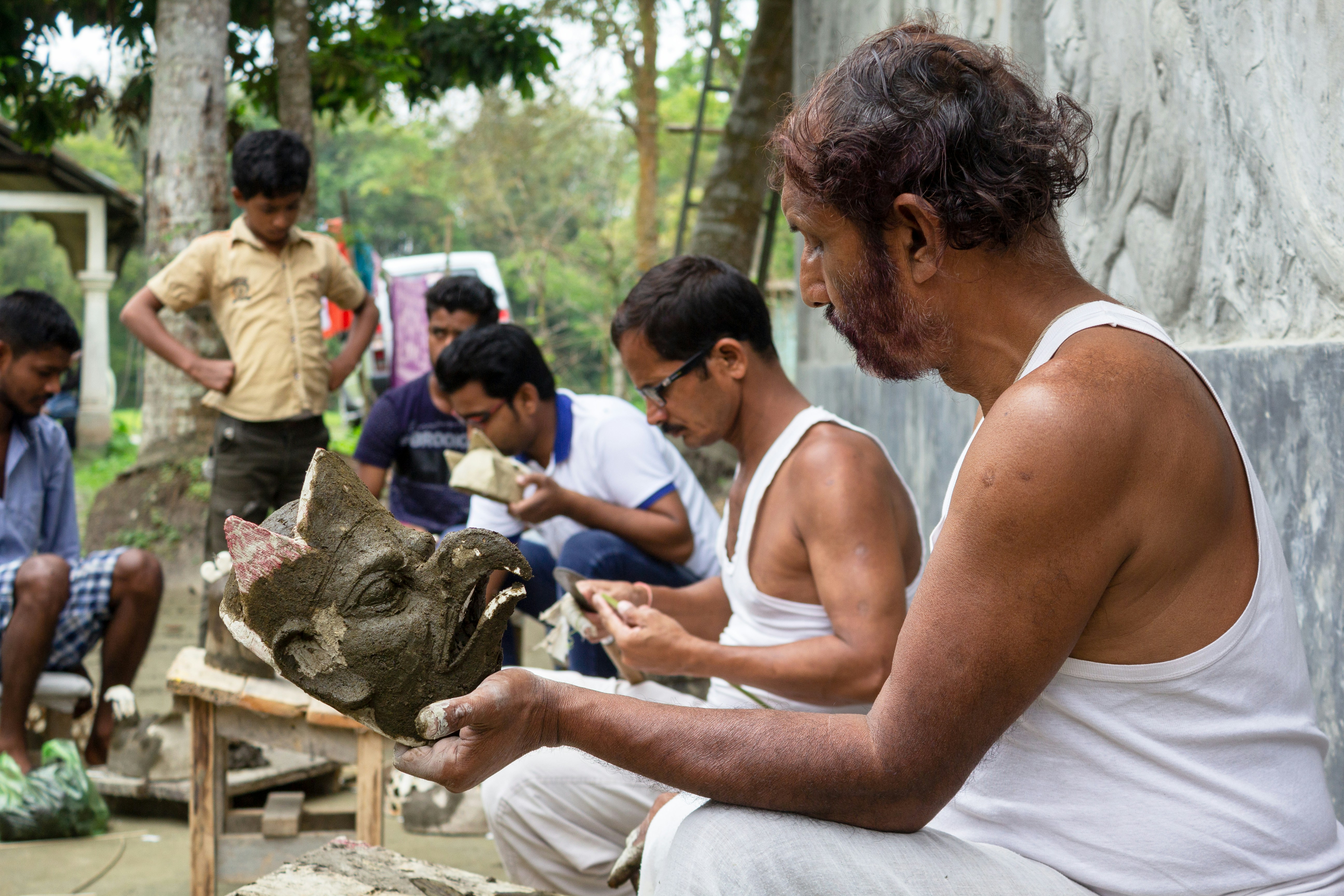 Man making traditional masks