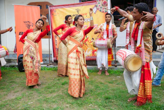 Performers in traditional attire dance to drum music.