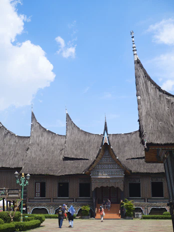 Traditional building with unique roof under blue sky.