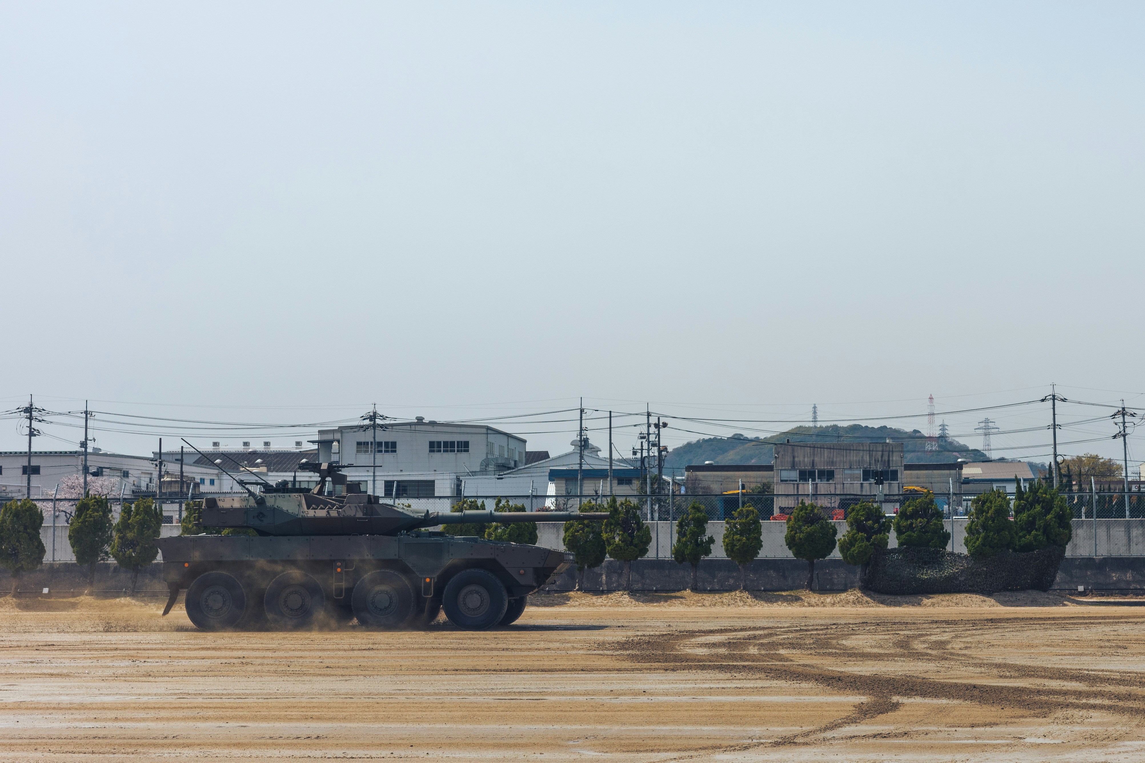 Armored vehicle driving on dusty ground