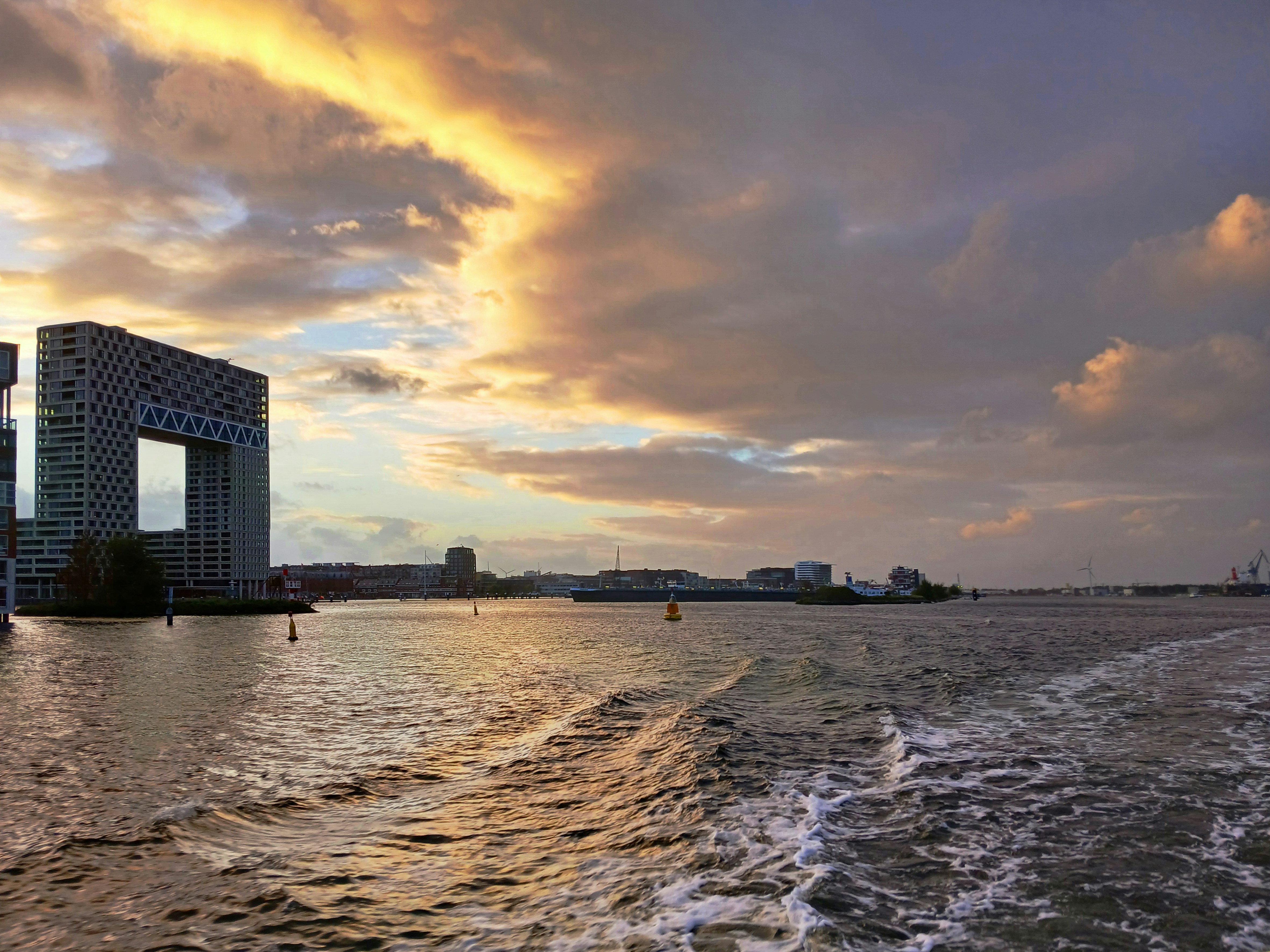 Modern buildings on the water at sunset