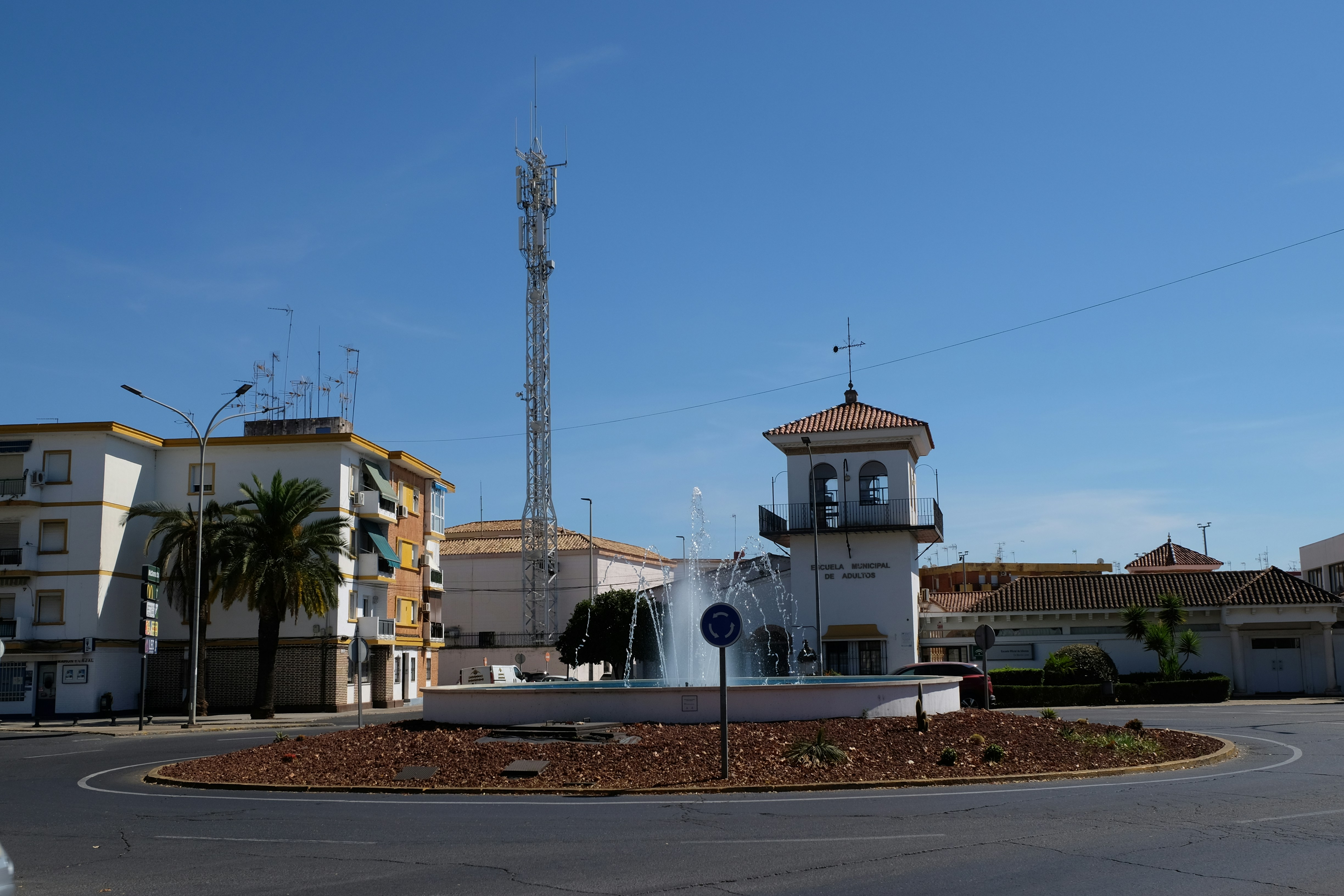 Roundabout with a fountain and tower in town.