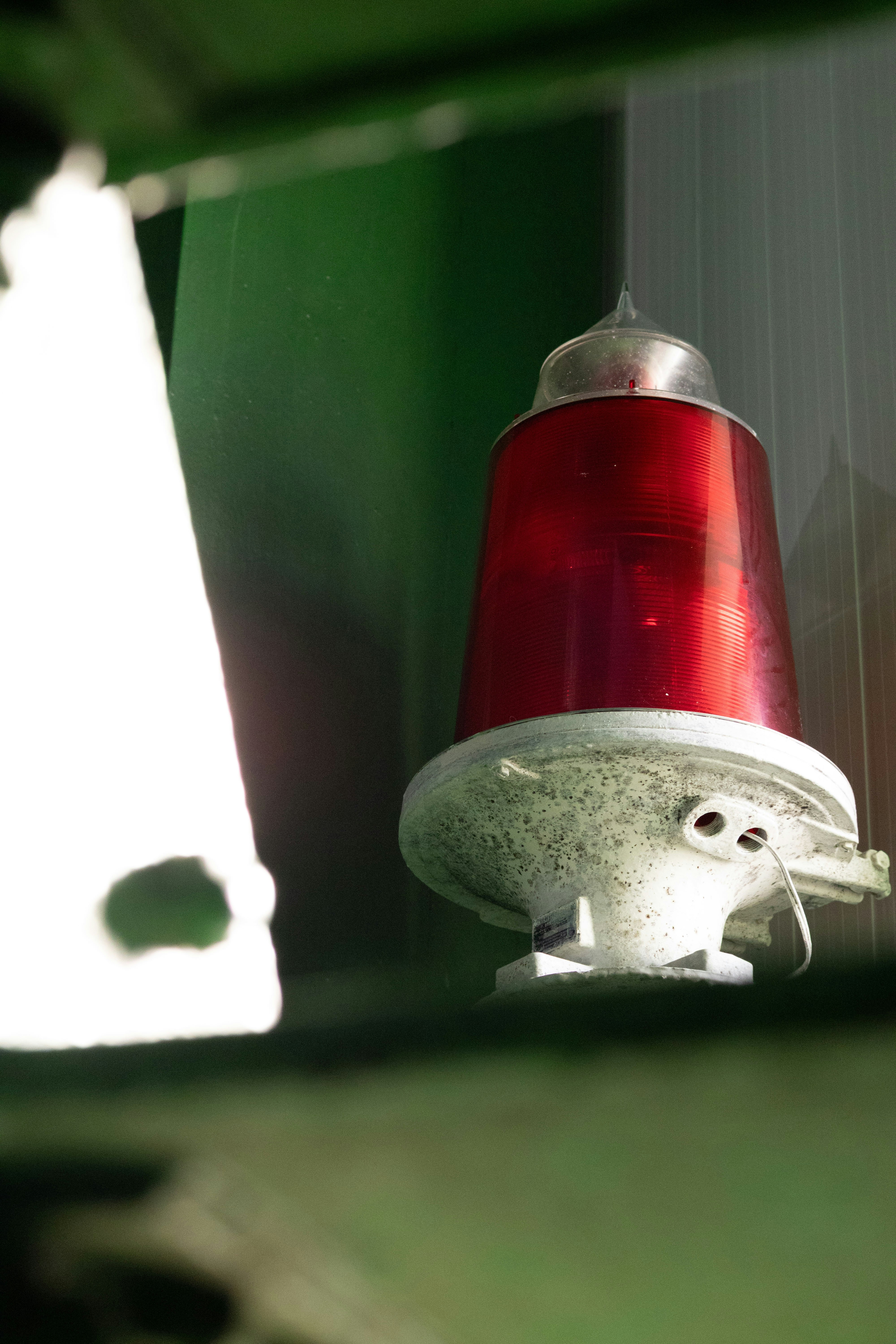 A red warning light on a green background
