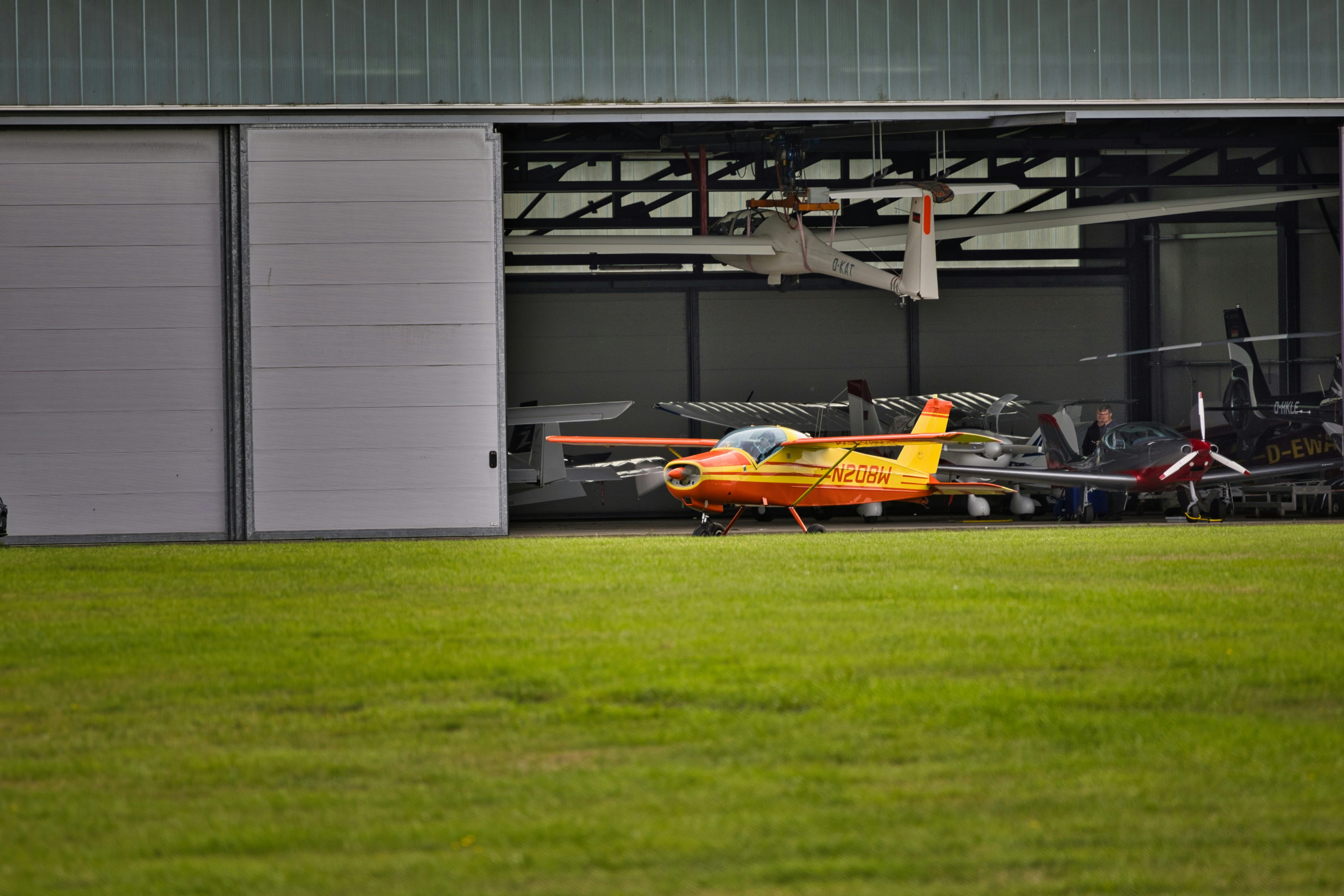 three person standing near wall inside building