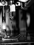 Sewing machine stitching components at a Sialkot OEM sports gear manufacturing facility.