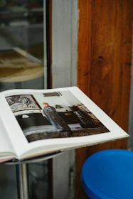 Open book displaying artwork on a table.