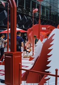 People gathered around a red abstract art installation