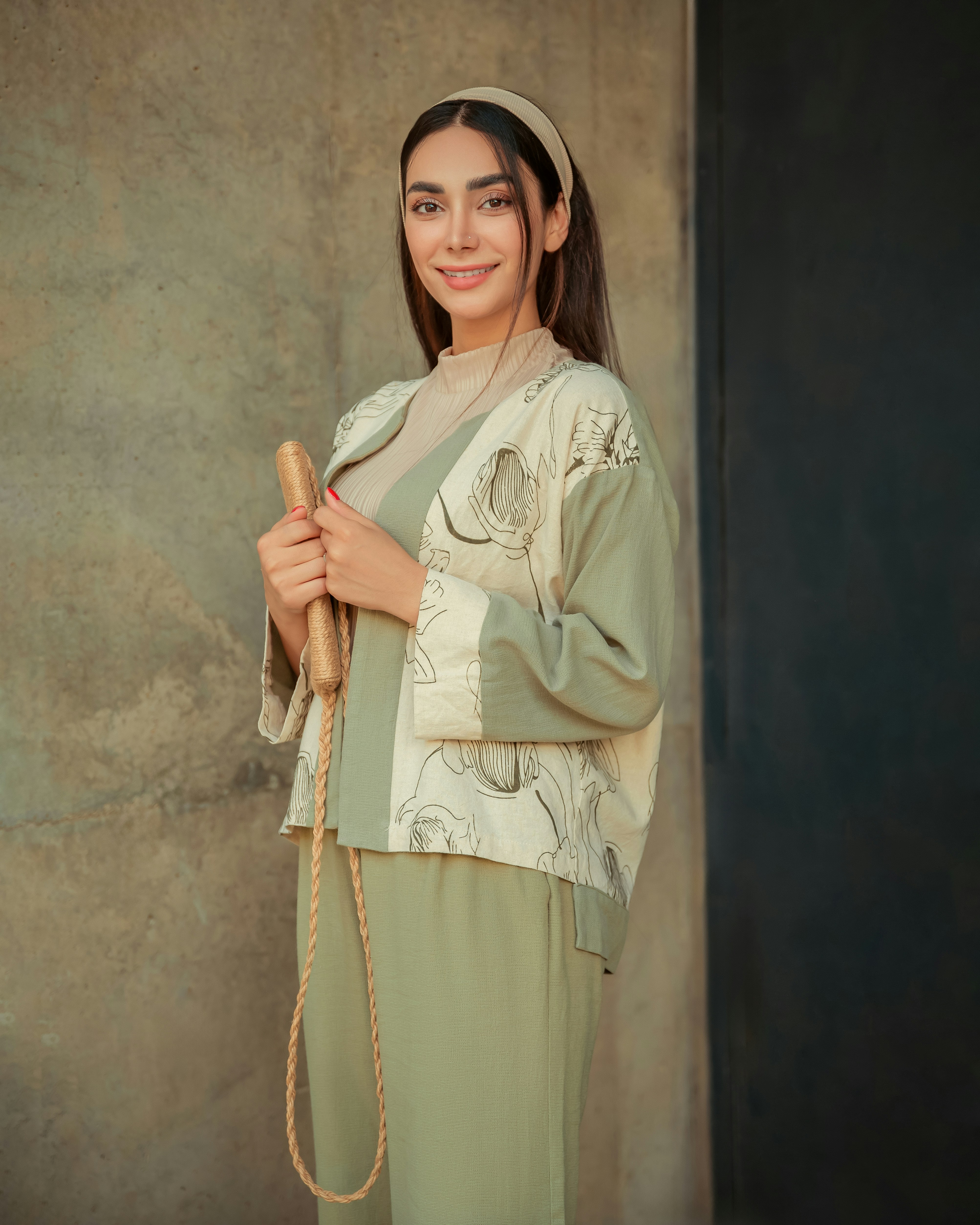 Young woman holding a jump rope with a smile