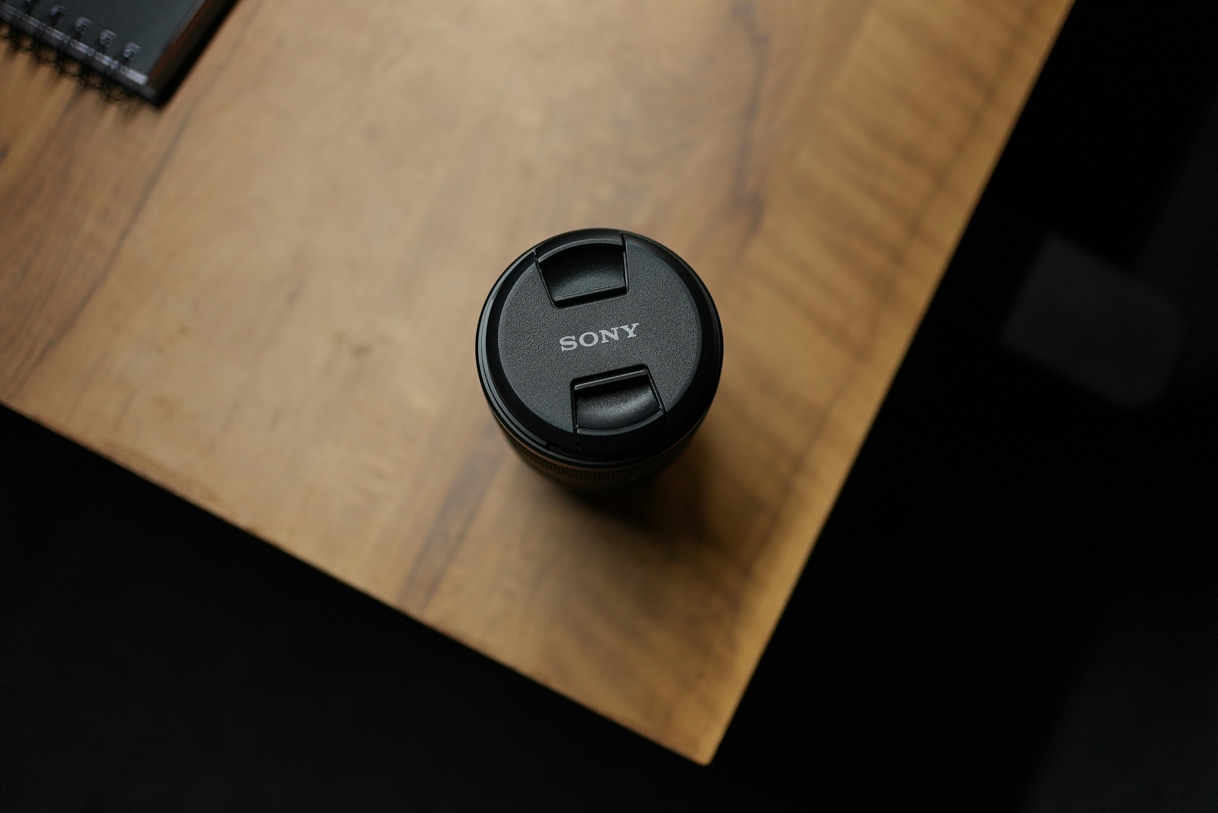 Sony lens cap on a wooden table