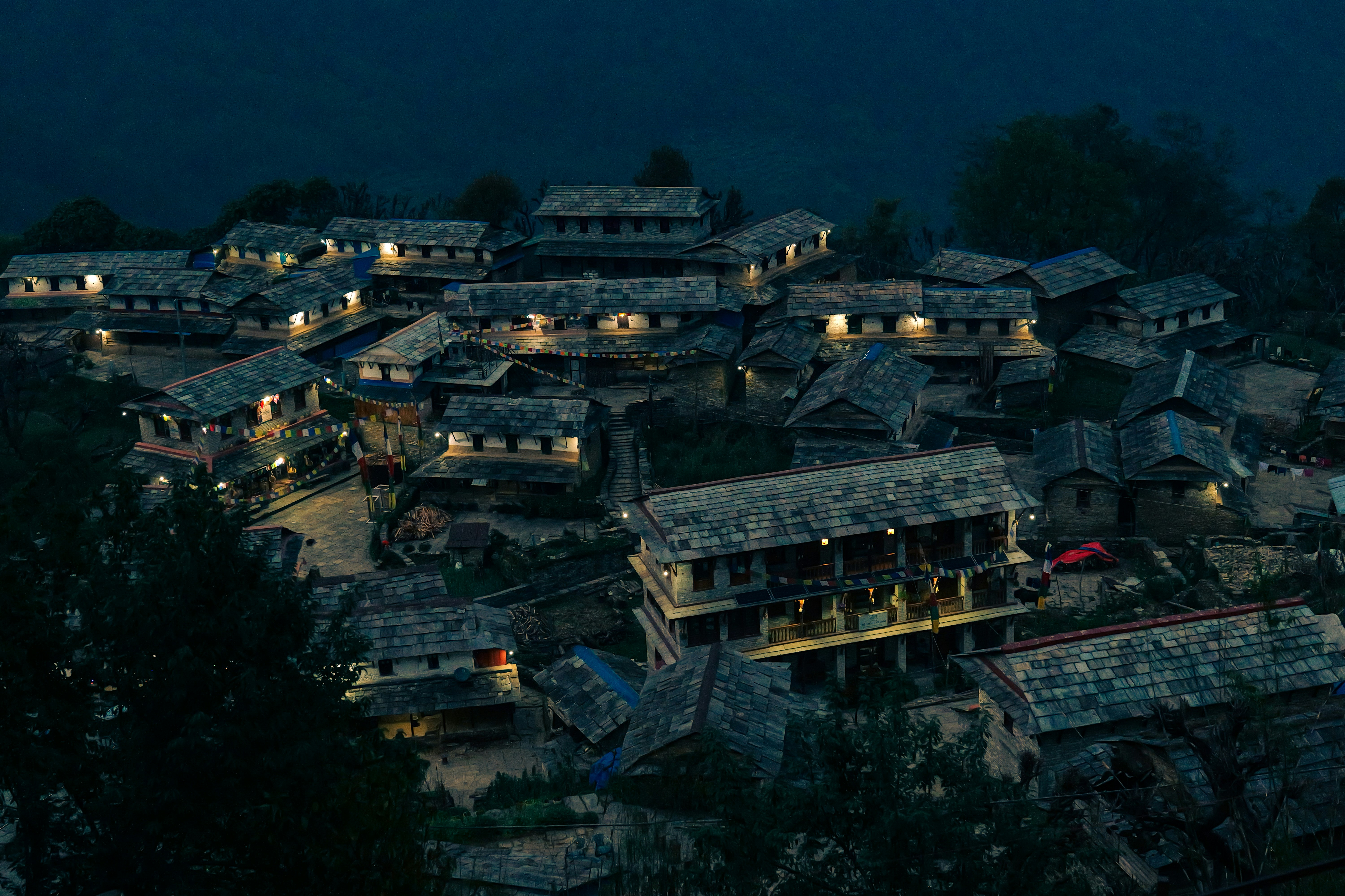 Village nestled in hills at night
