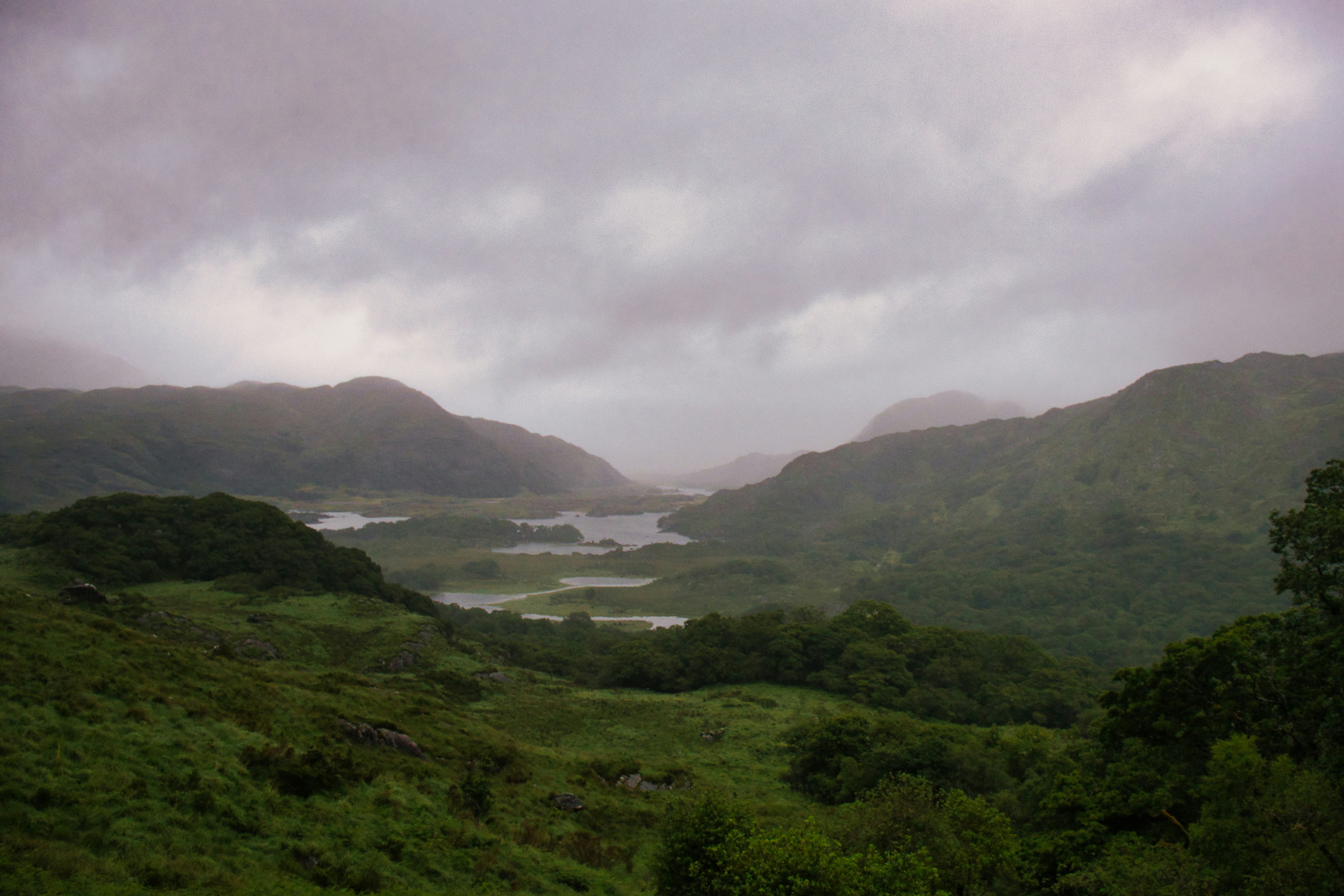 Misty mountains and lakes under a cloudy sky
