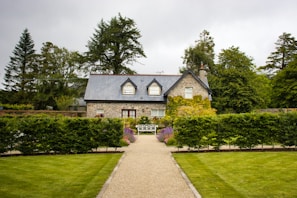 Stone cottage with manicured garden and pathway