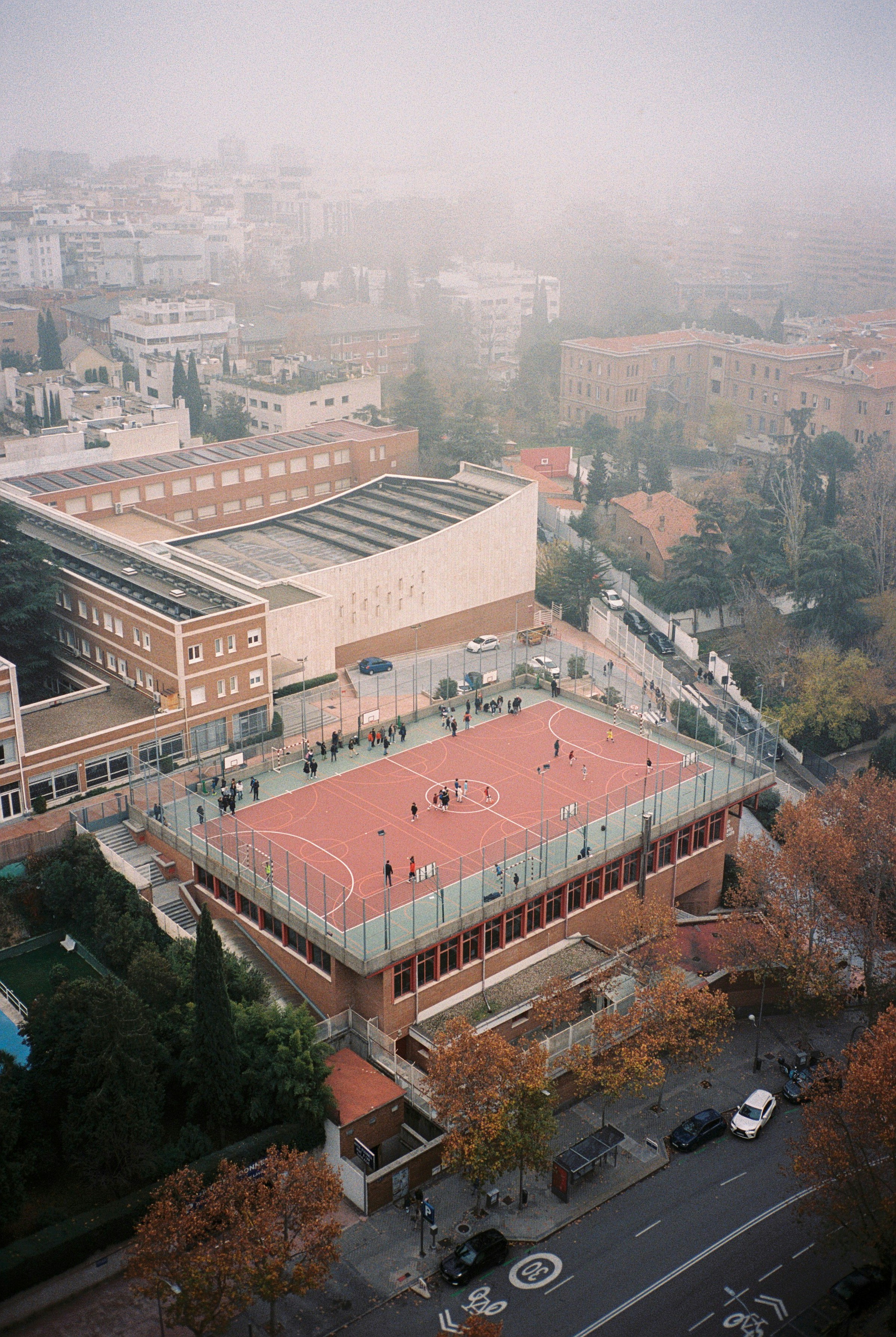 Aerial view of a sports court on a foggy day.