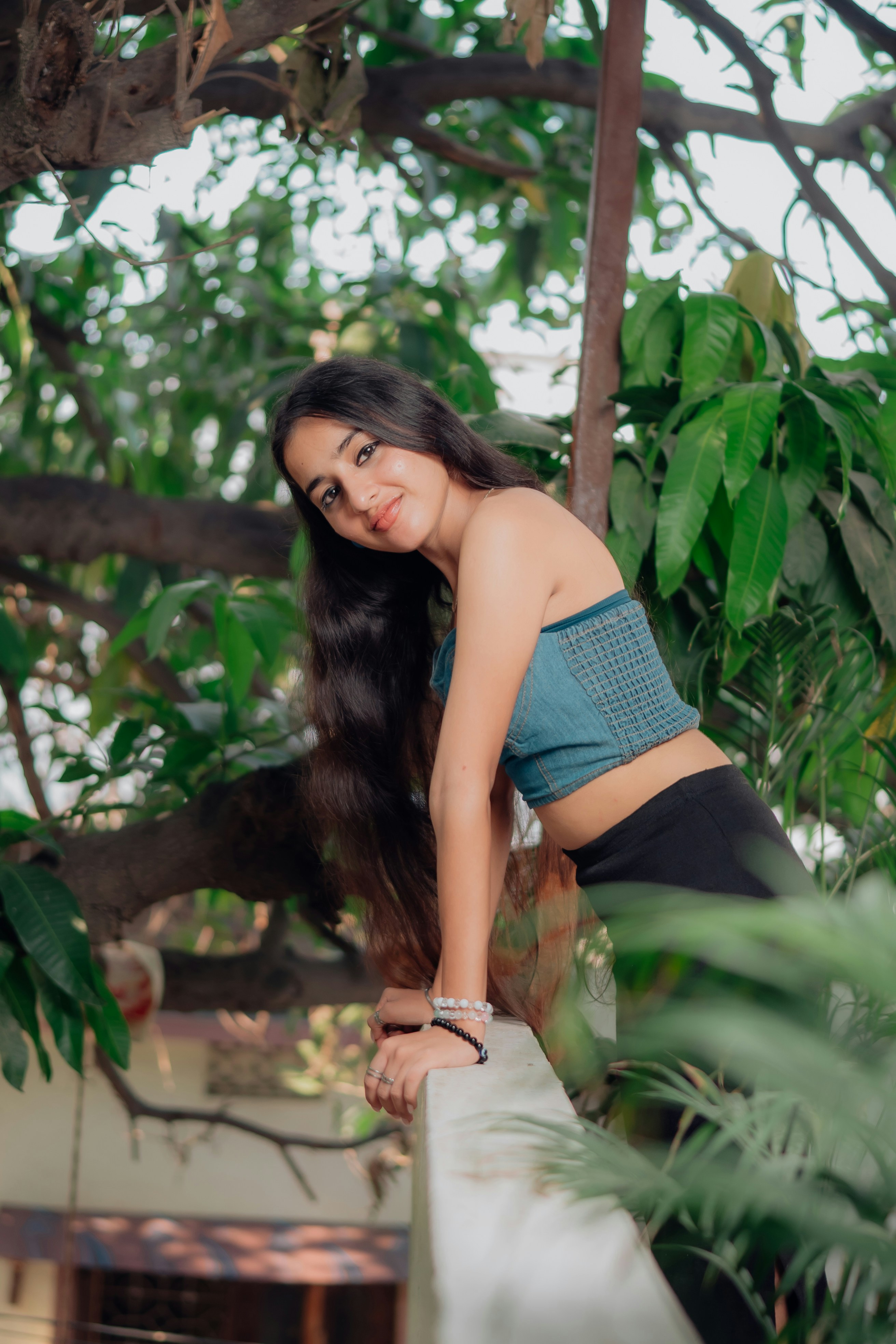 Young woman with long dark hair in a blue top.