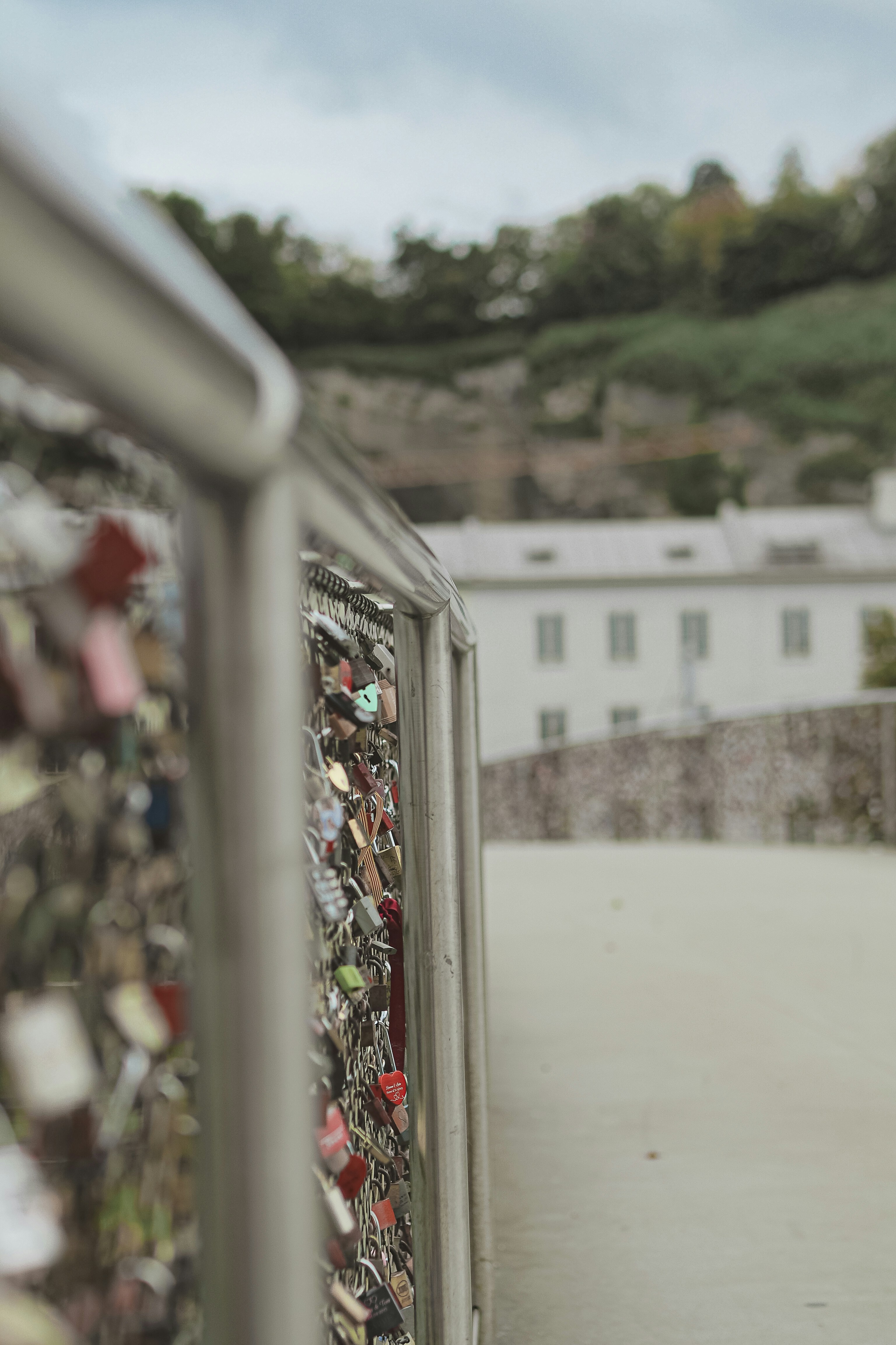 Love locks on a bridge railing with building background