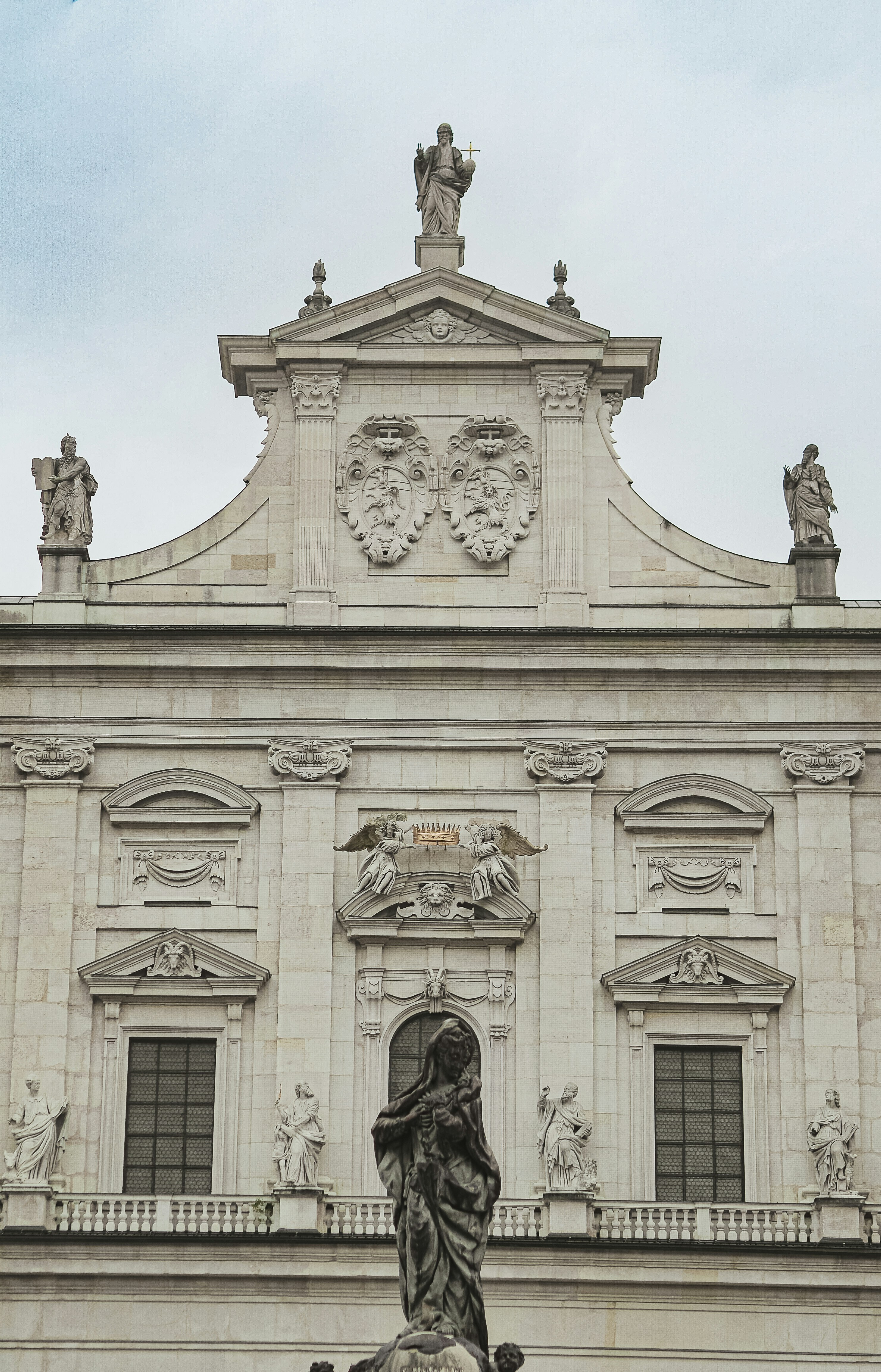 Stone facade of a grand building with statues.