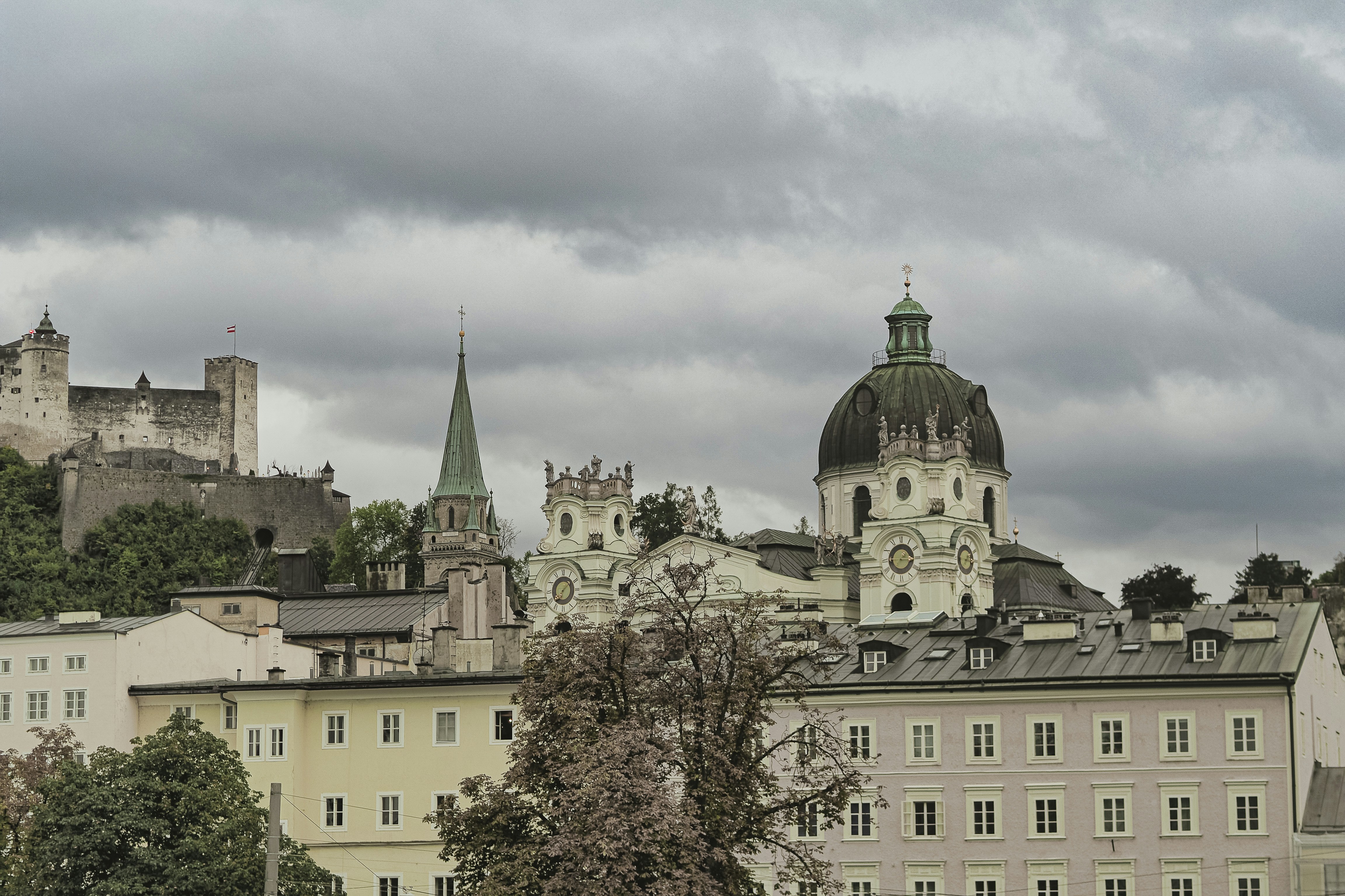 Historic buildings and castle under cloudy sky