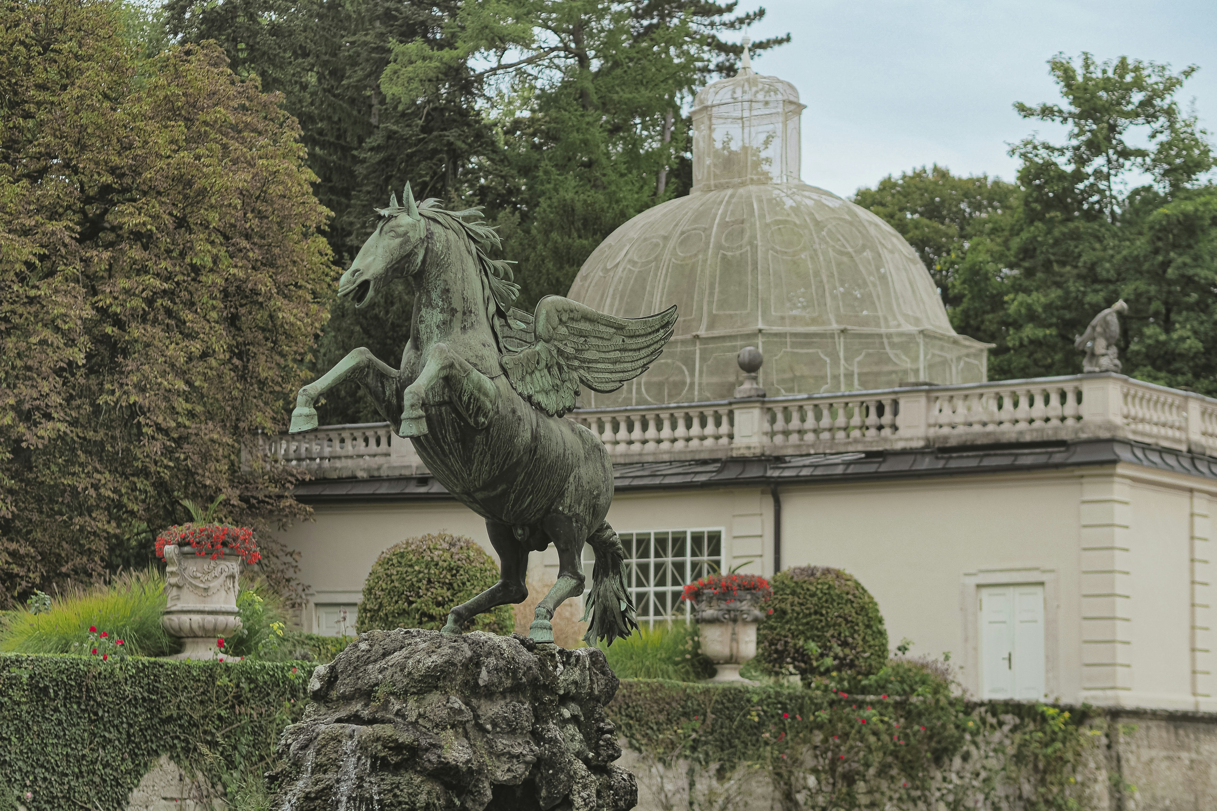 Pegasus statue in front of a domed building