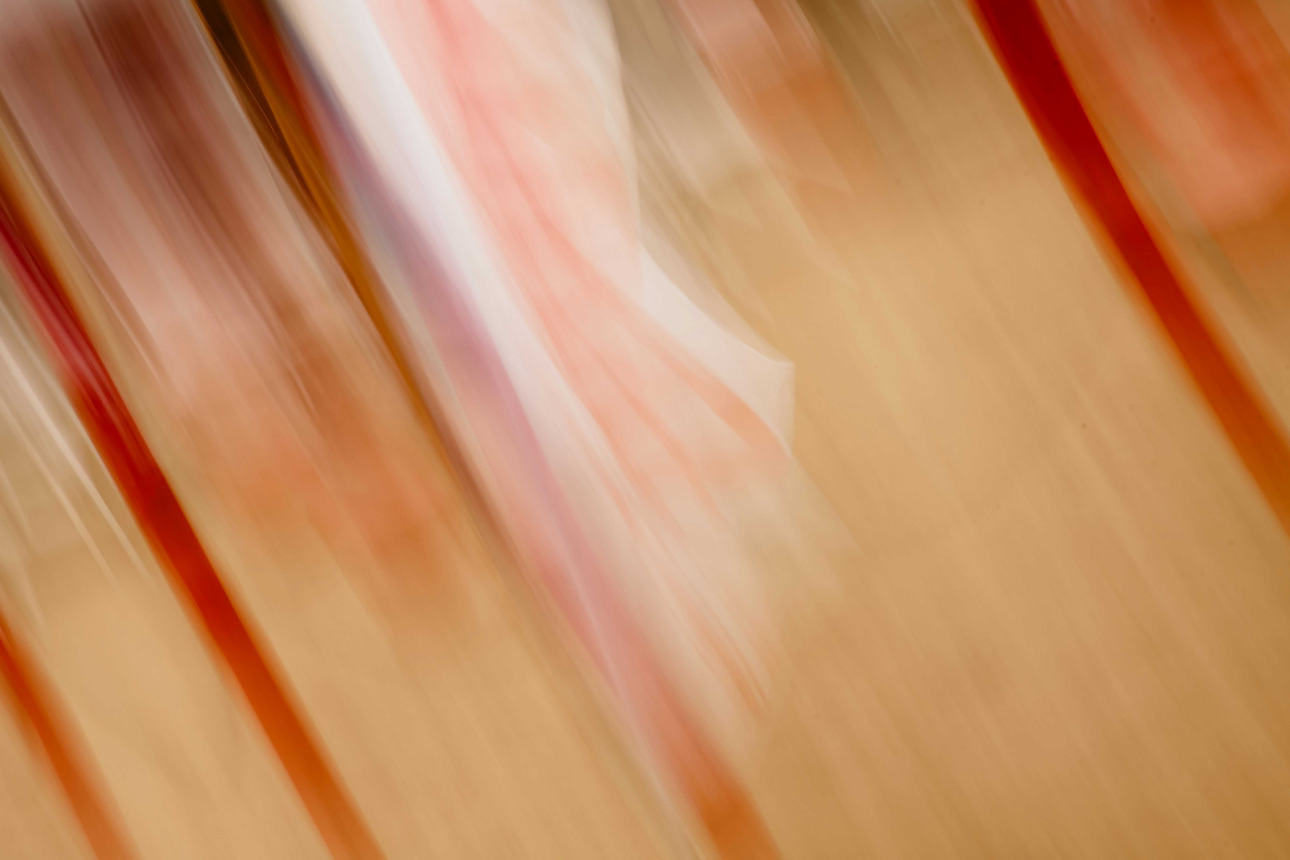Abstract streaks of red and white on beige background