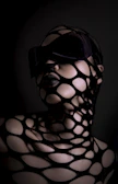 Woman with black mesh covering face and body