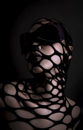 Woman with black mesh covering face and body