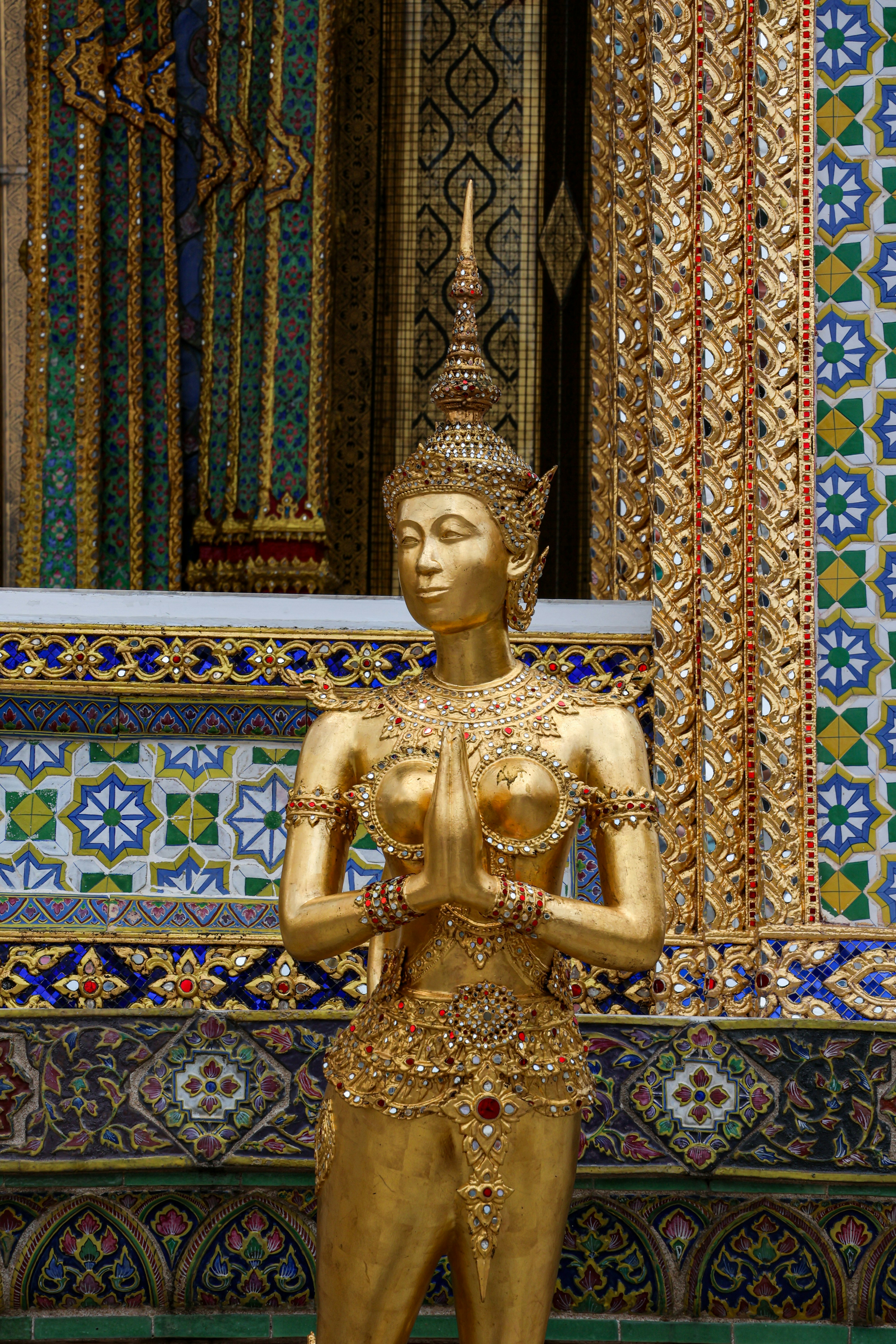 Golden statue with hands clasped in prayer