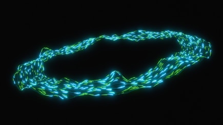 A glowing blue and green ring on black background