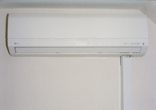 A white air conditioner mounted on a wall.
