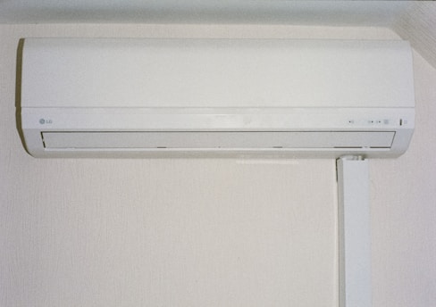 A white air conditioner mounted on a wall.