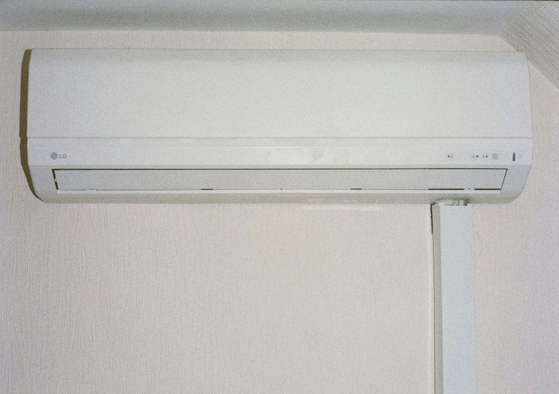 A white air conditioner mounted on a wall.