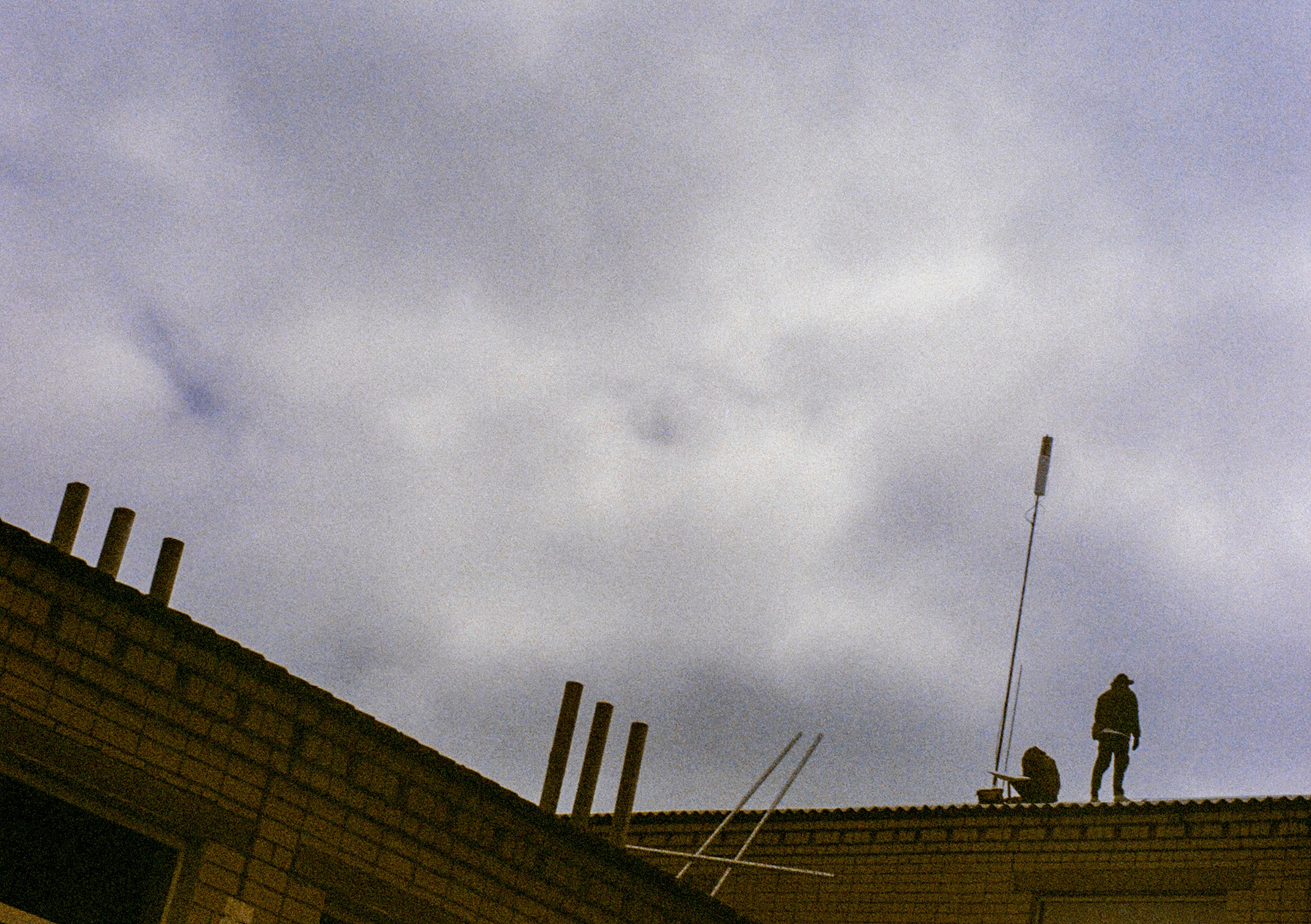 Roofer inspecting storm damage with a drone - tall pines roofing rochester ny