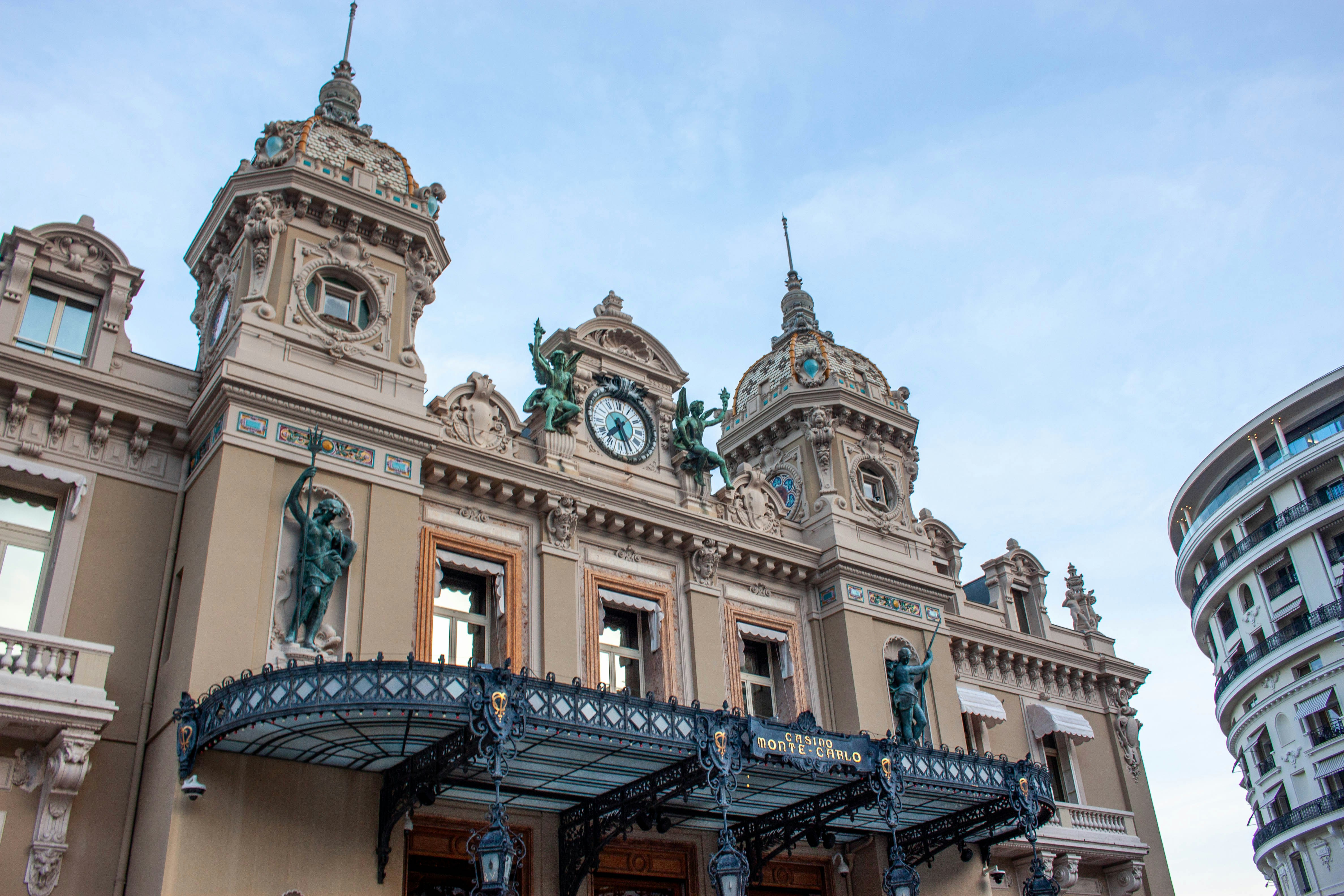 Grand ornate building with clock tower and blue sky