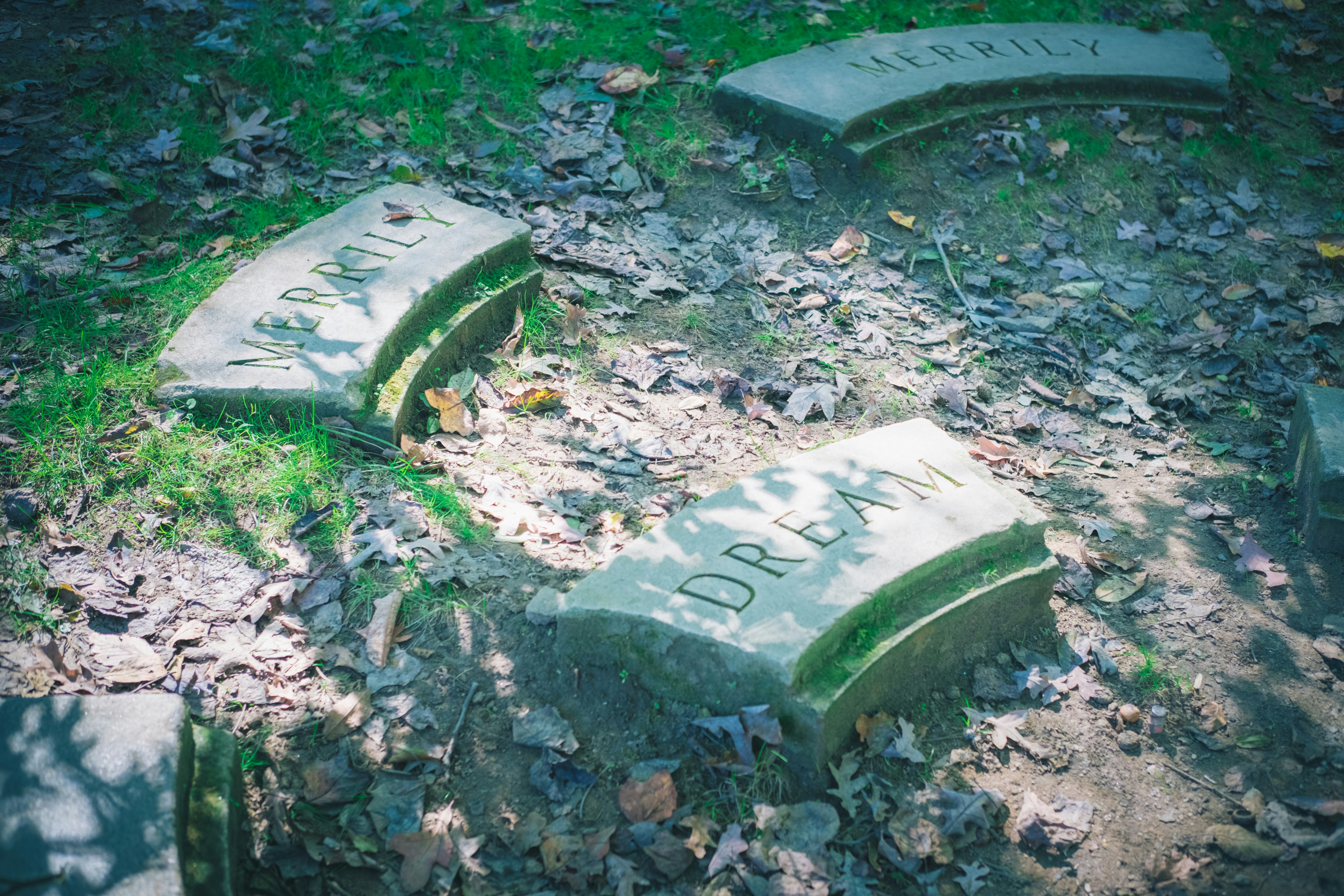 Broken gravestone pieces on the ground