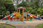 Colorful playground with slides and climbing structures.