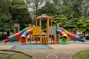 Colorful playground with slides and climbing structures.