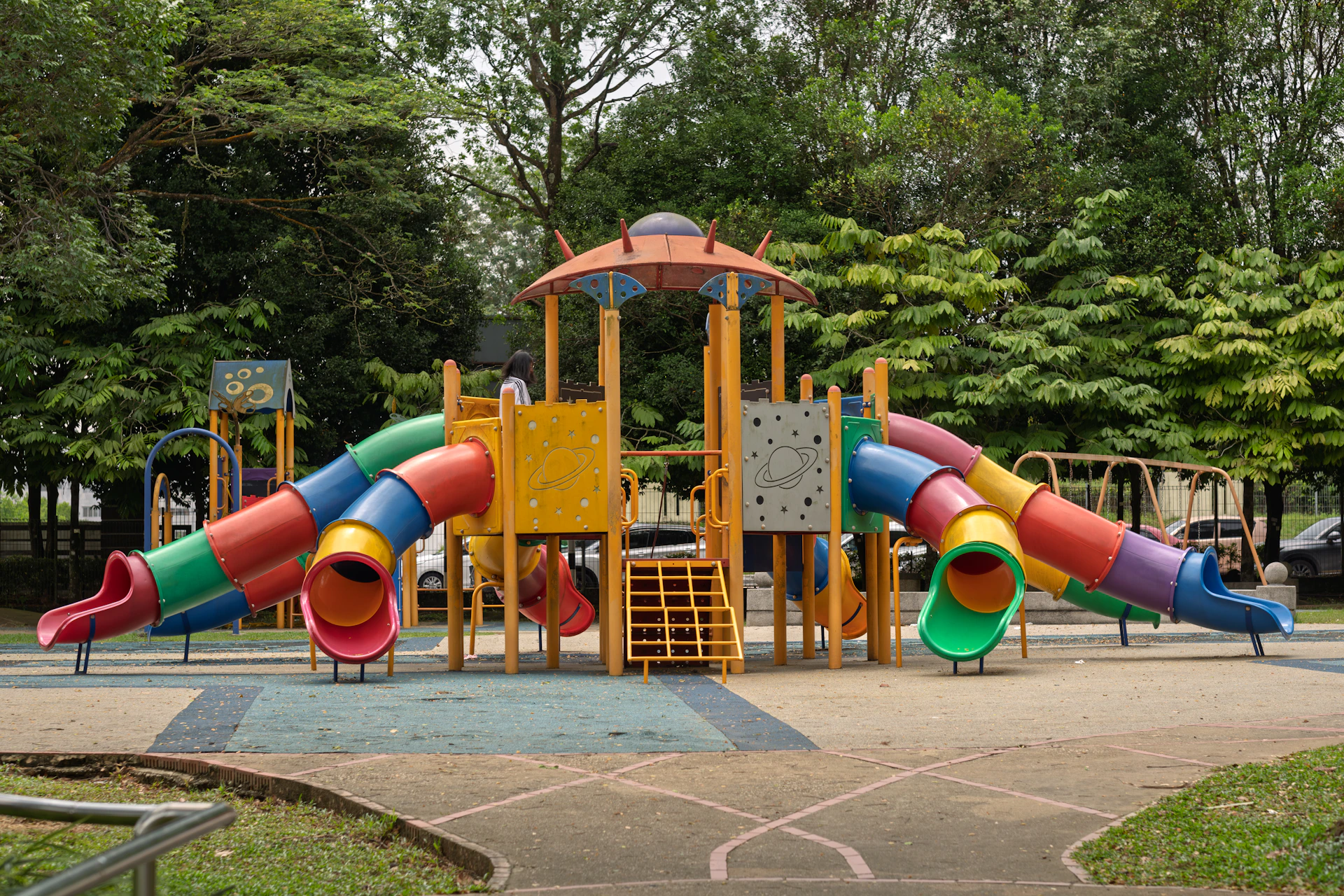 Colorful playground with slides and climbing structures.