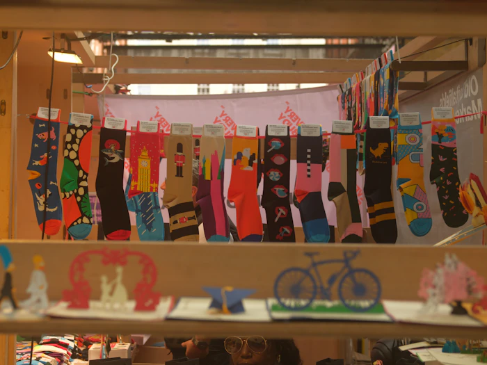 A hanging line of brightly patterned socks on display