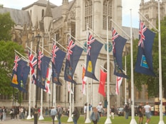 British flags displayed in front of a large building.