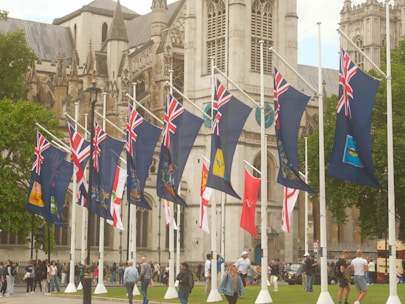British flags displayed in front of a large building.