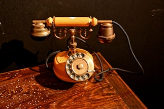 Antique rotary telephone on a wooden table