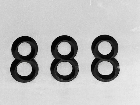 Three sets of stacked black rings forming eights